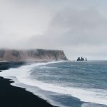 black sand near body of water