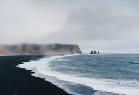 black sand near body of water