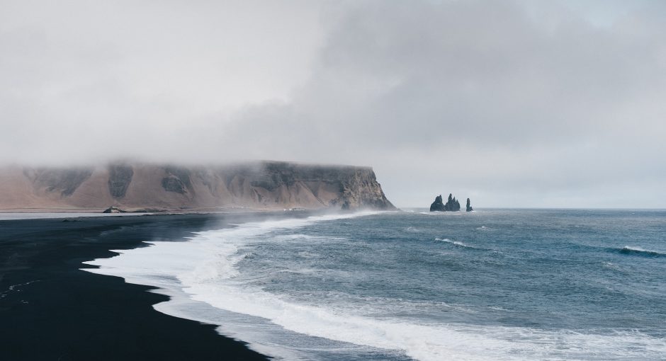 black sand near body of water