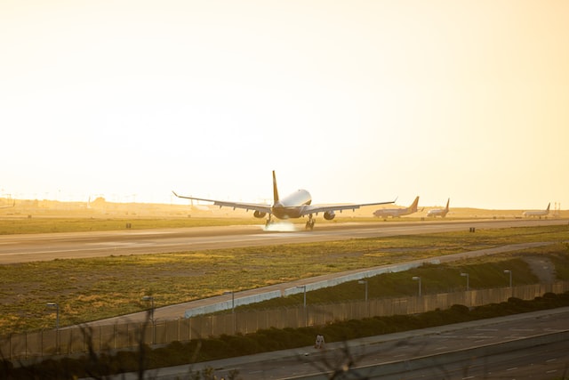 gray airplane at runway