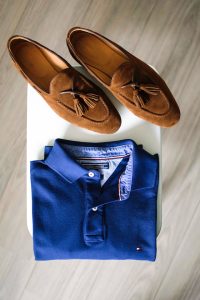 pair of brown loafers and blues polo shirt